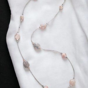 Infinity necklace featuring natural grey stone accented with soft shade of peach